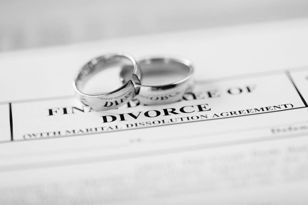 Two wedding rings on a divorce document form - ev law in Bundall, QLD