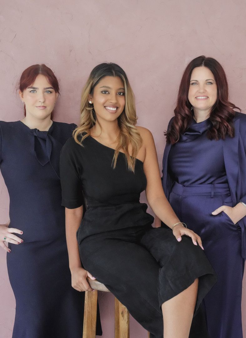 A Man In A Suit Is Shaking Hands With A Woman In Front Of A Scale Of Justice — EV Law In Bundall, QLD