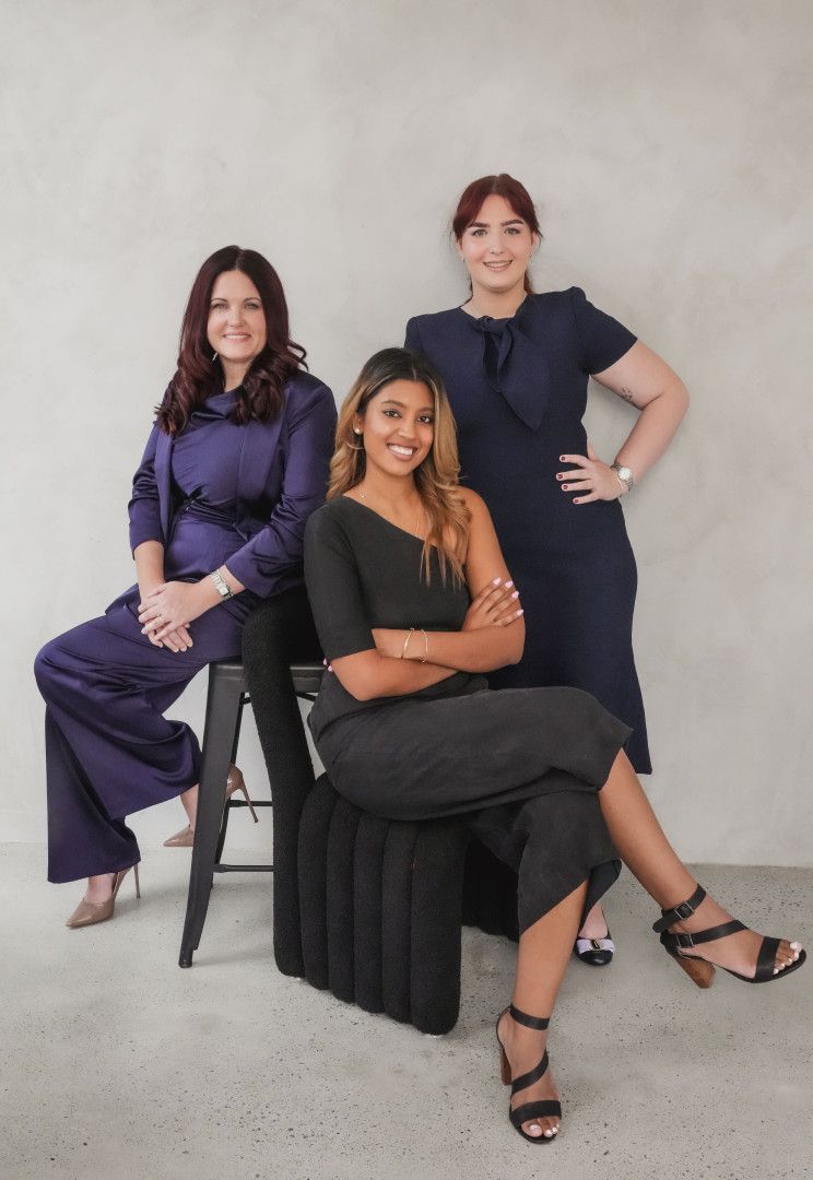 Three Women Are Posing for a Picture — EV Law In Bundall, QLD