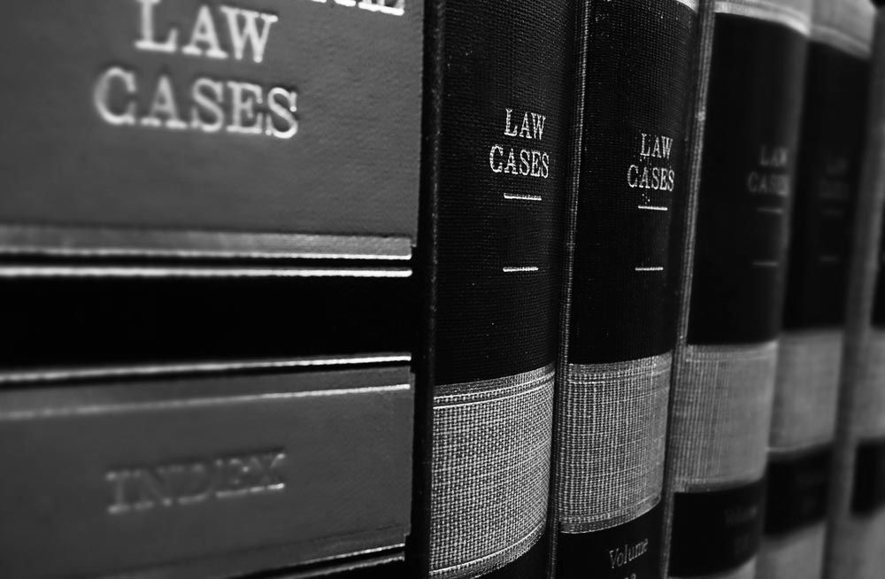 Row of black law books on a shelf, one labeled “LAW CASES.” - ev law in Bundall, QLD