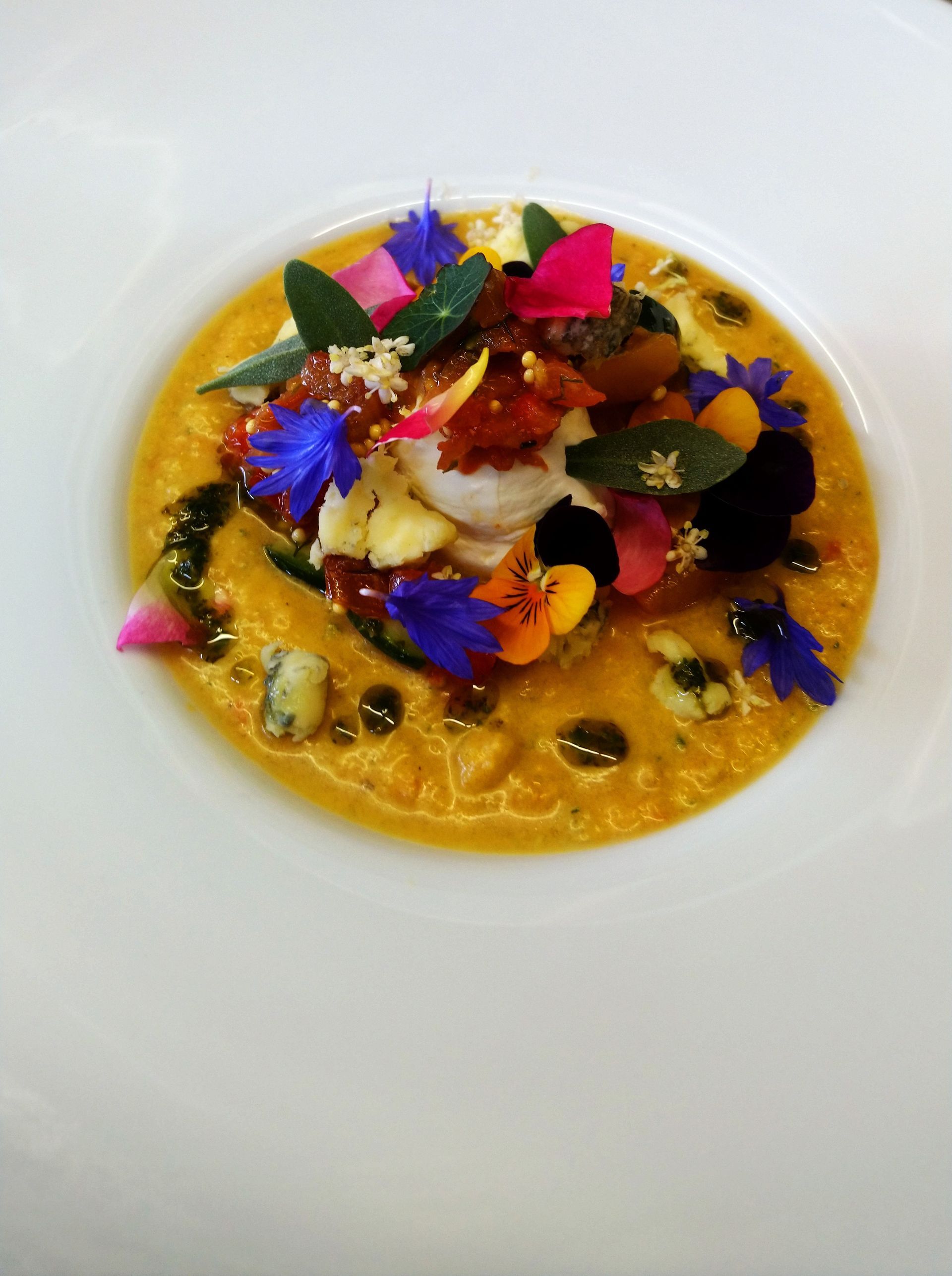 A close up of a plate of food with flowers on it