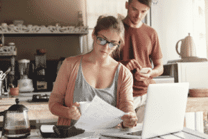 Young Couple Working on Their Utility Bills — Lisle, IL – Jim Dhamer Plumbing and Sewer, Inc.