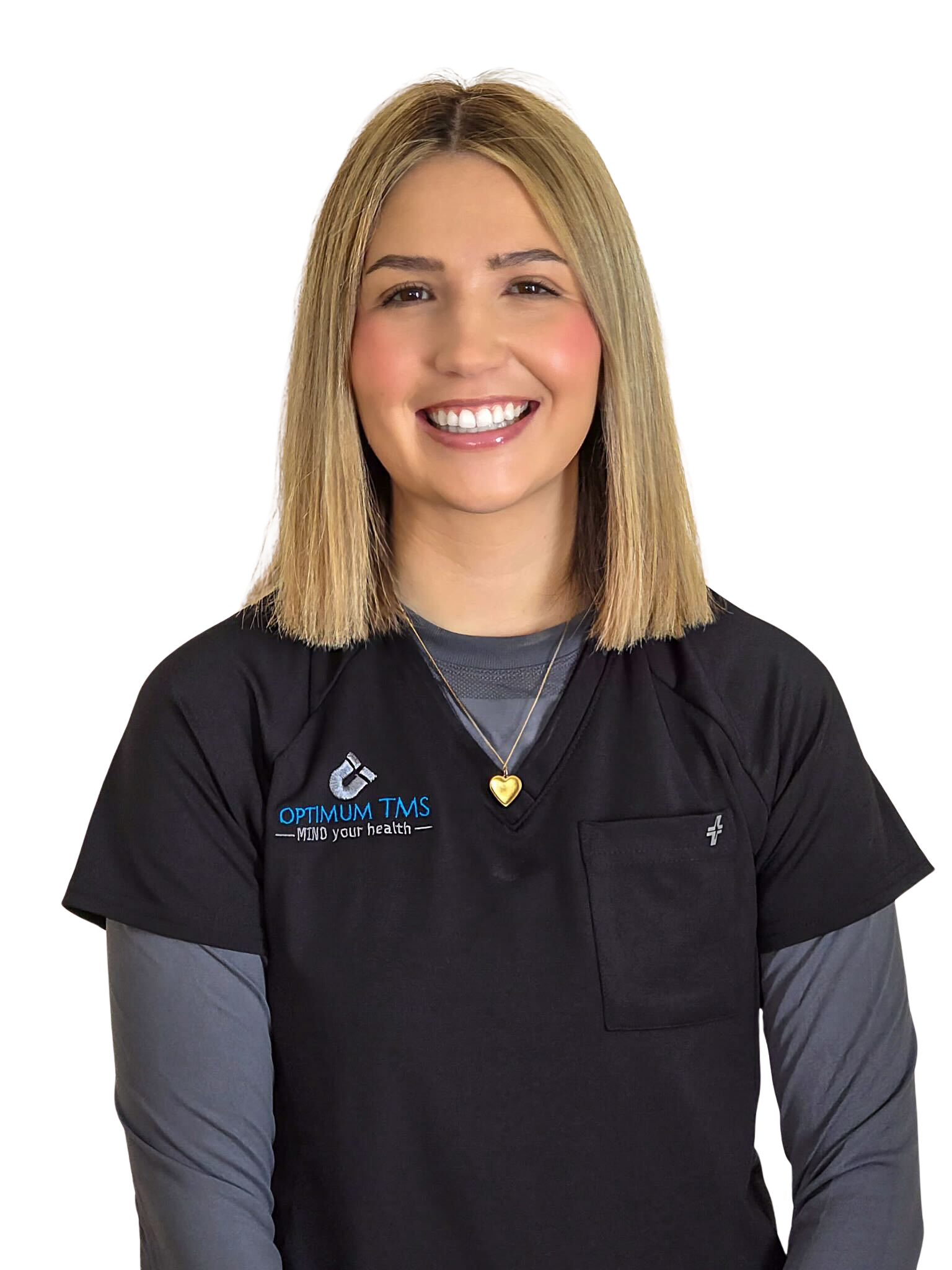 A woman in a black scrub top is smiling with her arms crossed.