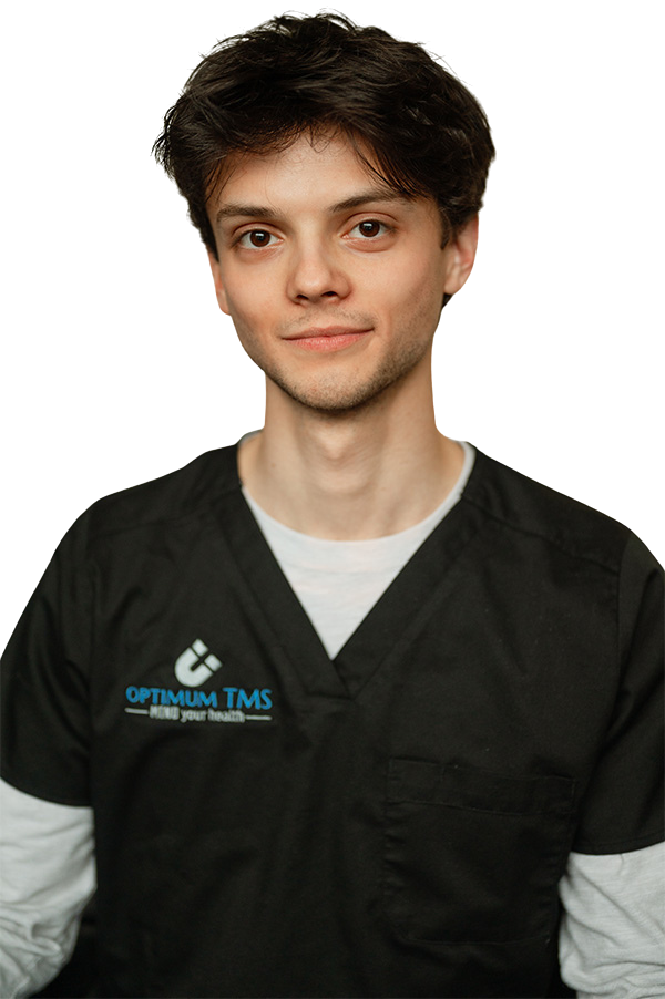 A young man wearing a black scrub top with the word optimum on it