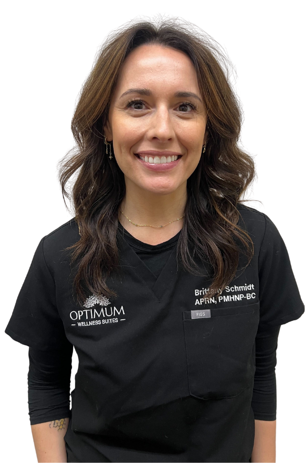 A woman with curly hair is wearing a headband and a black scrub top.
