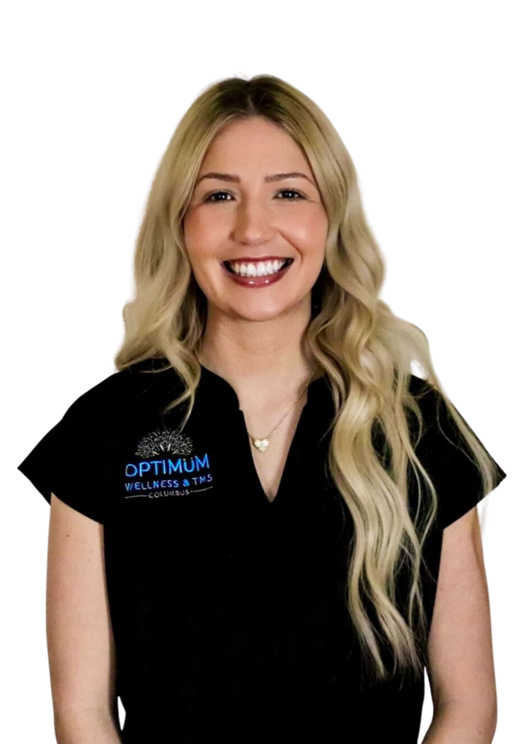 A woman in a black scrub top is smiling with her arms crossed.