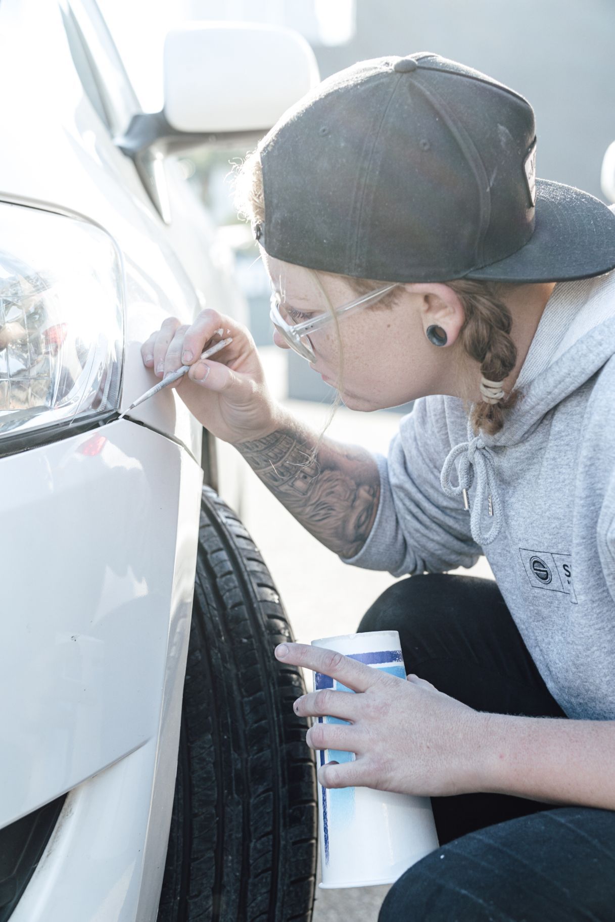 Woman Detailing Car Above Wheel — Panel Beaters in Southport, QLD