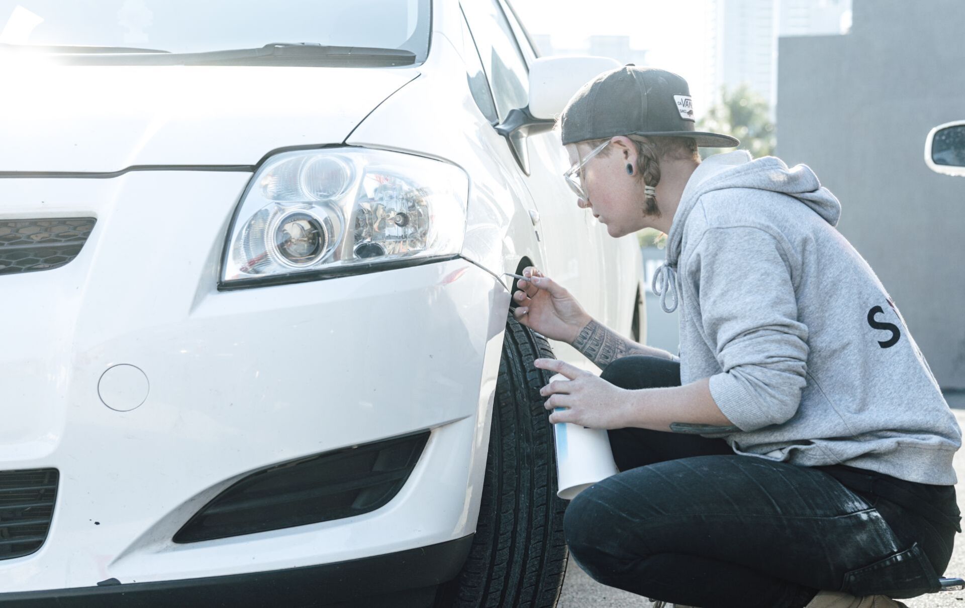 Woman Detailing Car Above Wheel — Panel Beaters in Southport, QLD