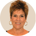 A close-up of dark green palm fronds radiating outward, showing detailed, repeating linear patterns.