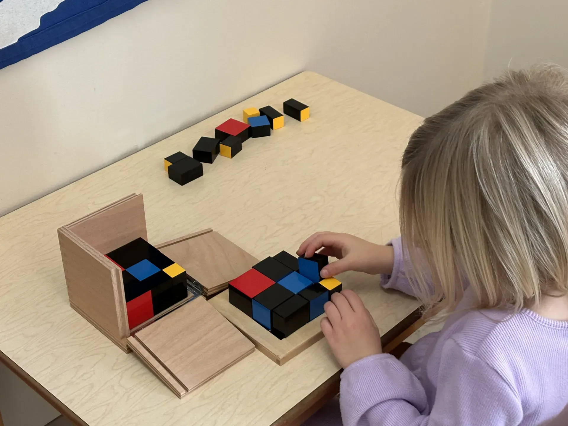 Montessori child working with binomial cube