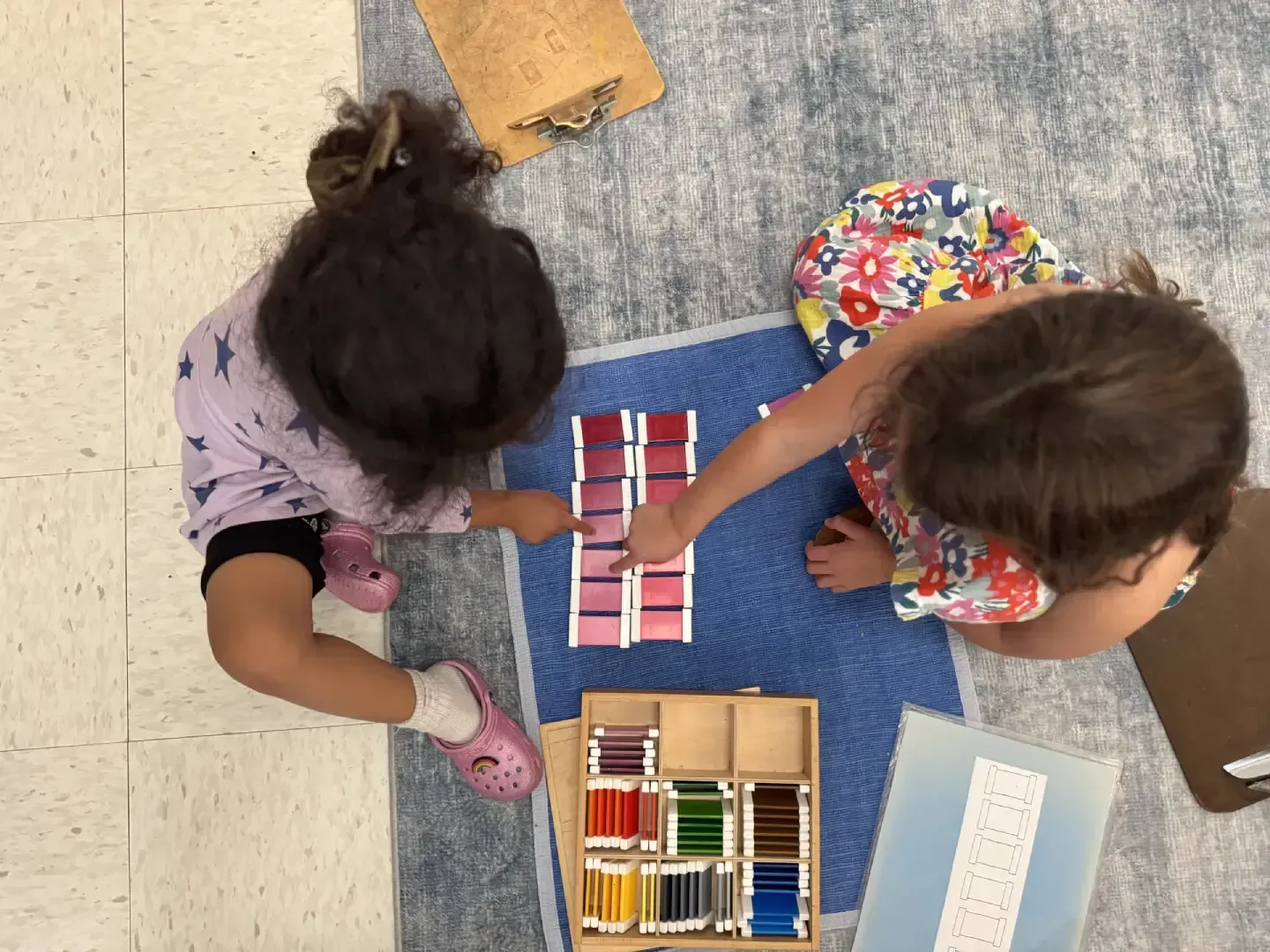 Montessori children working in the classroom with Montessori materials