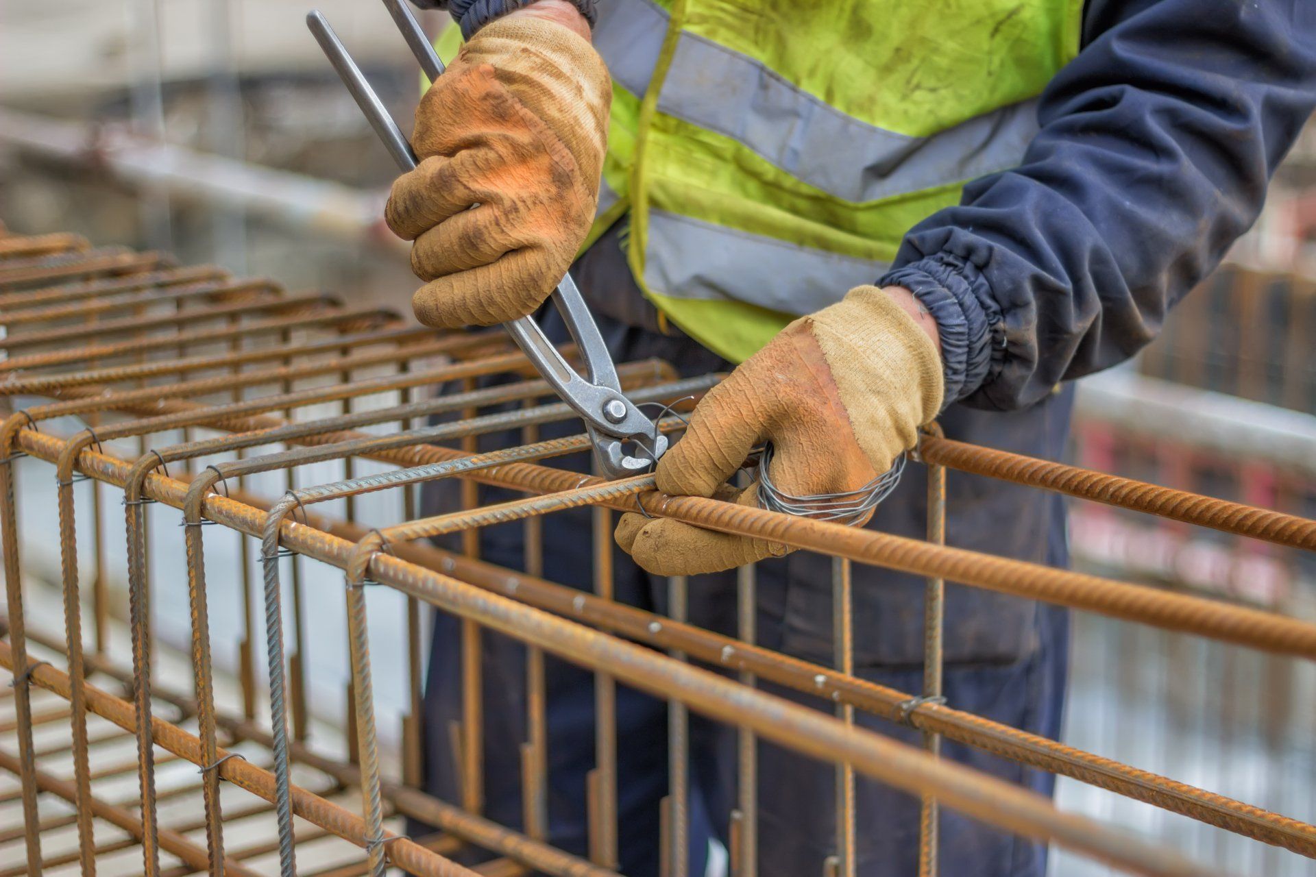 Workers hands using steel wire — Benny’s Concrete Formwork & Reinforcement in Northern Rivers, NSW