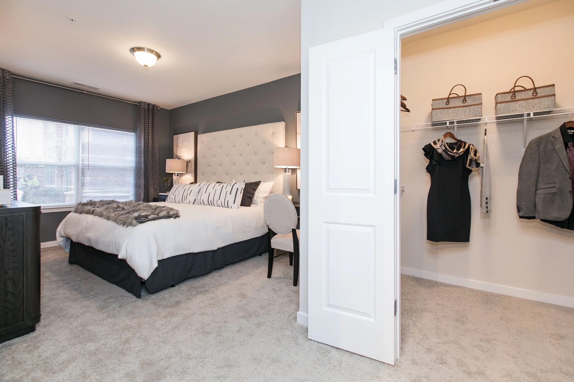 Carpeted bedroom and walk-in closet at Verde at Howard Square.