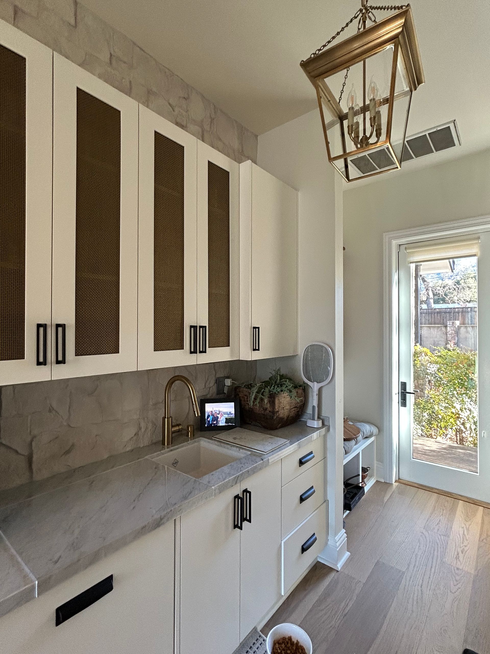 Elegant, curved staircase with dark wood railing and white steps; sconces on the wall.