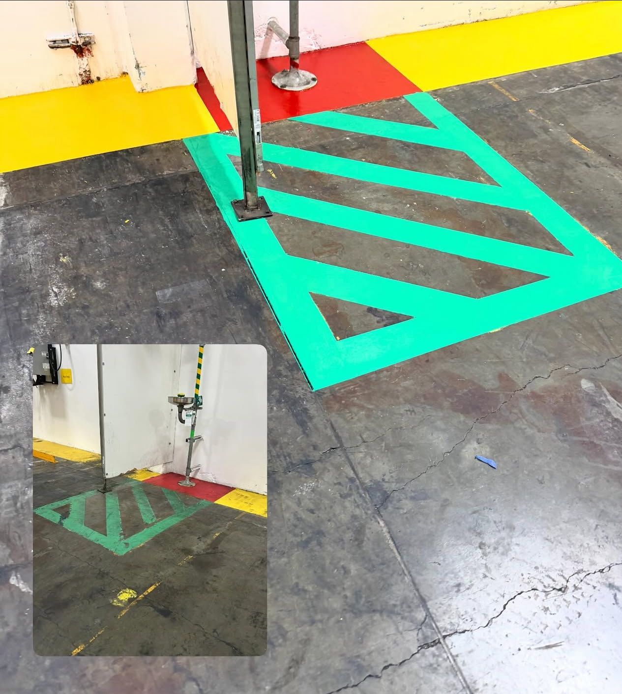 Floor markings indicating an area with a safety shower. Green and red paint on concrete floor.