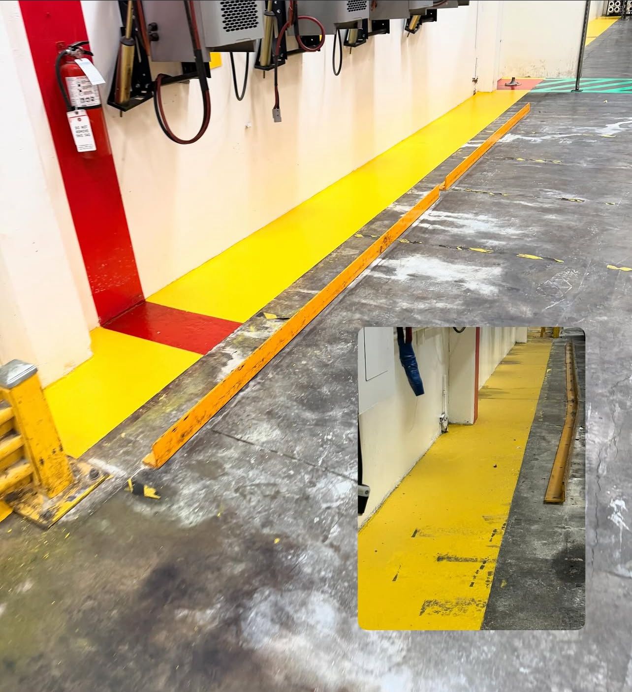 Yellow painted walkway with raised metal edging in a factory setting.