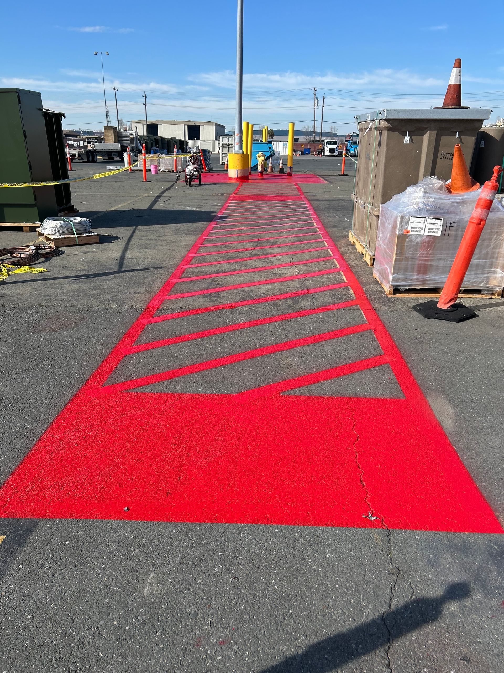 Exterior view of a vacant commercial building with large windows, a blue sky, and an arrow indicating the direction.