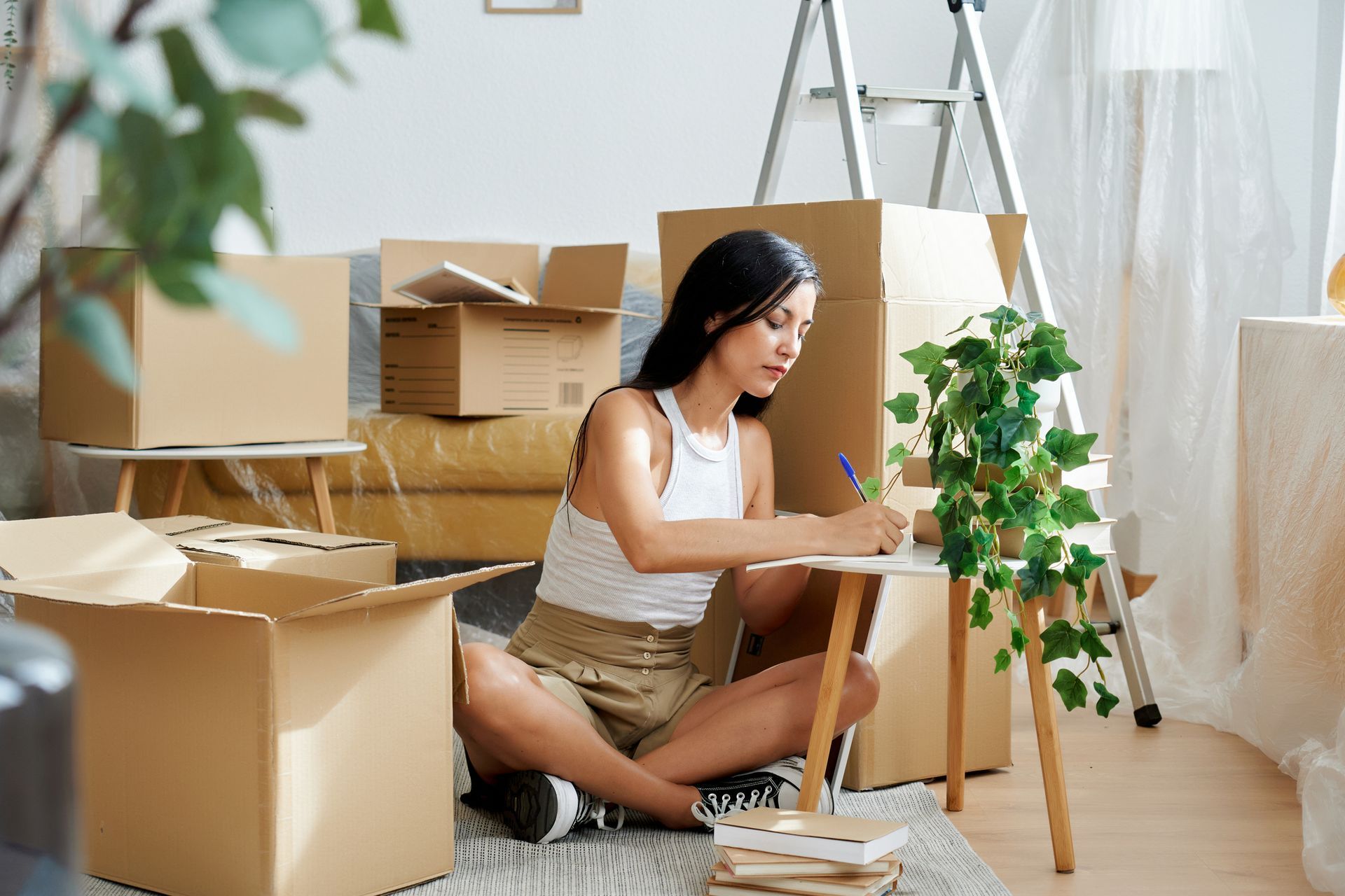 Woman doing checklist while packing for a new home.