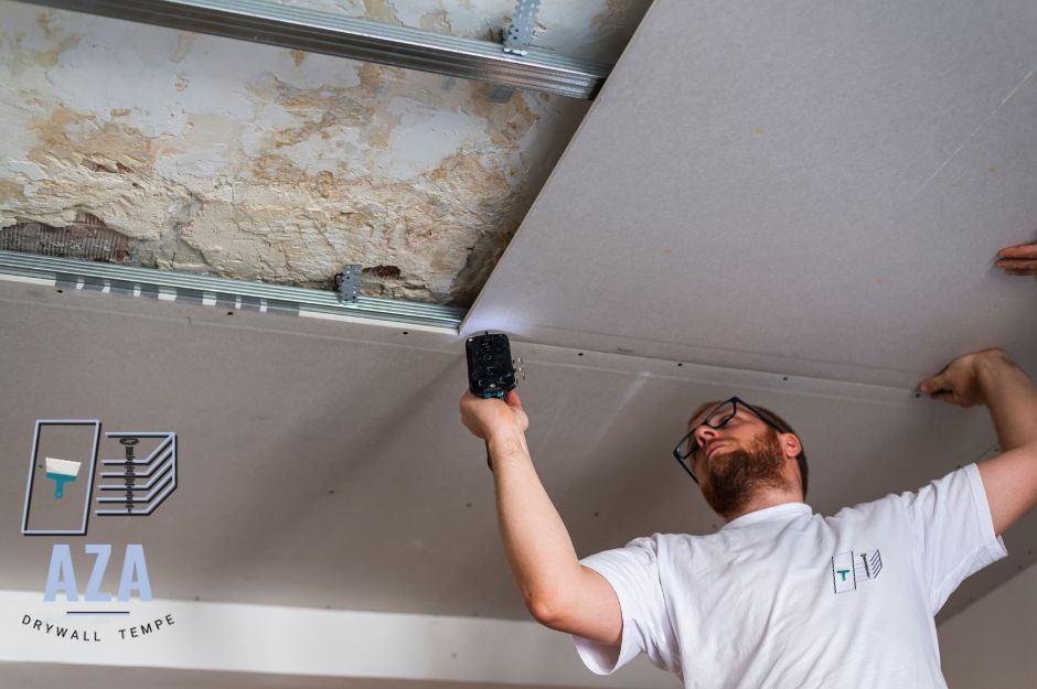 A male contractor is working on drywall hanging in Tempe, AZ in the Gililland neighborhood to ensure that installing drywall is done properly. 