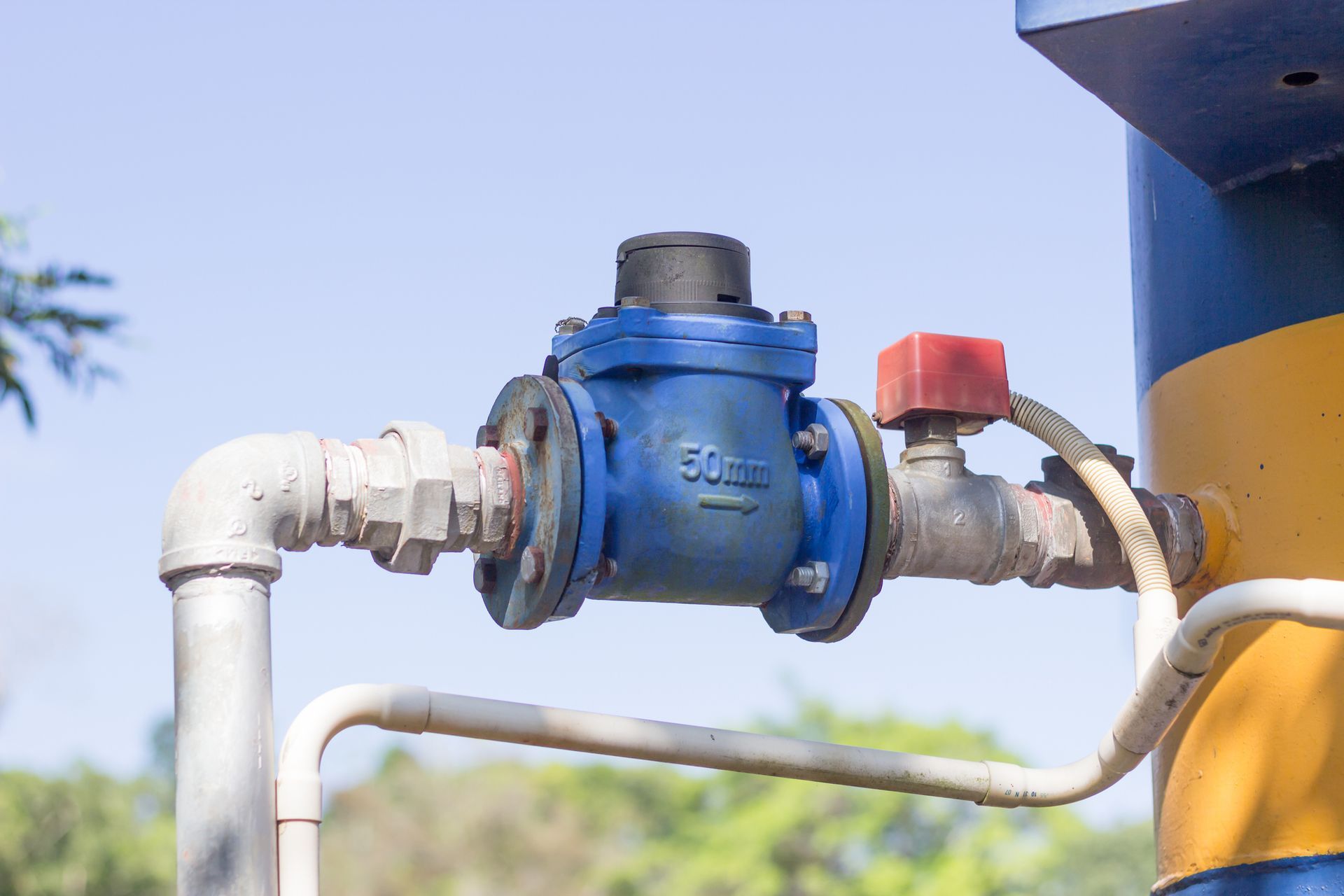 Blue and white pipe with a valve. Blue and white pipe with a valve.