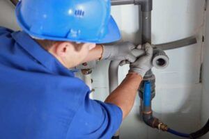Male Worker Inspecting Water Valve — Seattle, WA — Quality Plumbing