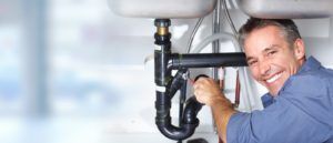 Plumber Fixing Pipe Under the Sink — Seattle, WA — Quality Plumbing