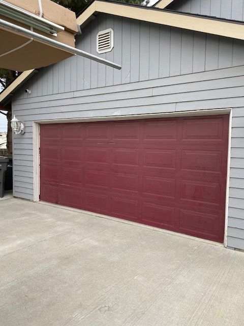 A Man Is Using a Drill to Install a Garage Door - Benton City, WA - Overton Garage Doors