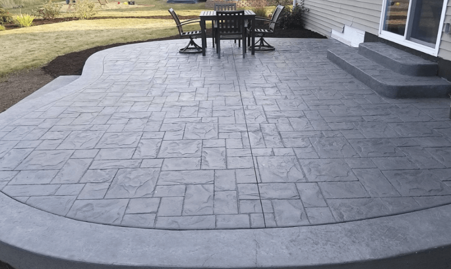 Concrete company pours and stamps a new patio in the backyard of a resident in oswego, IL