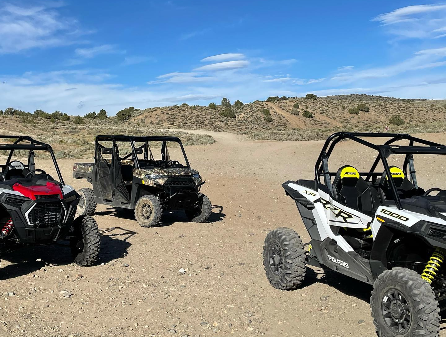 black and brown RZR on rocky trail in desert