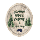 A logo for hominy ridge cabins and gift shop
