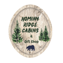 A logo for hominy ridge cabins and gift shop