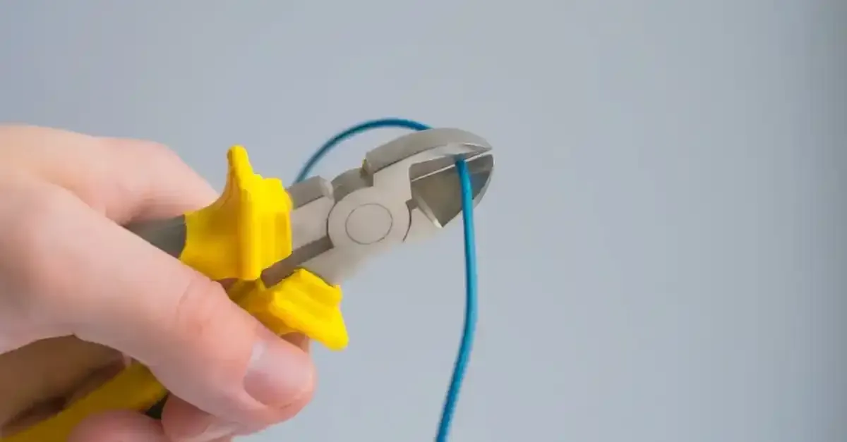 Pliers cutting an electrical cord symbolizing the shift from traditional cable to online streaming services in 2024