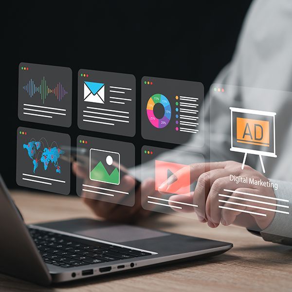 A person is using a laptop computer with a digital marketing screen coming out of it.