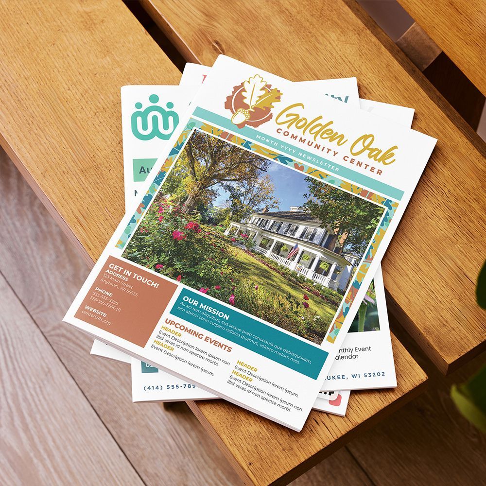 Stack of community newsletters with a beautiful brand design displayed at the top