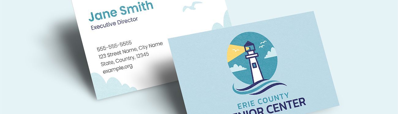 A business card with a lighthouse on it is sitting on a table.