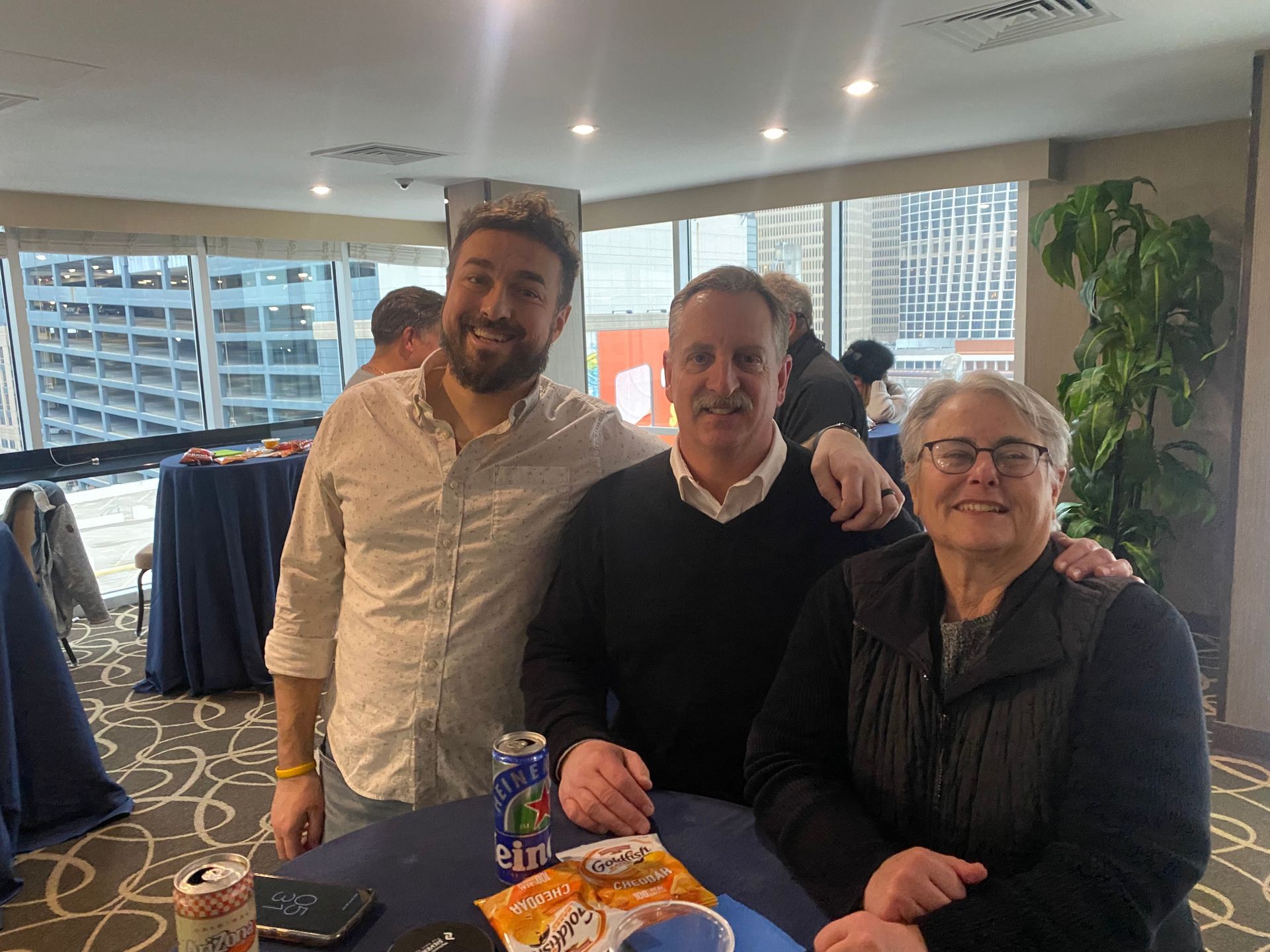 Three people smiling fort he camera