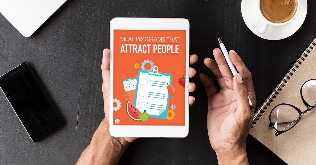 A person is holding a tablet that says attract people on it.