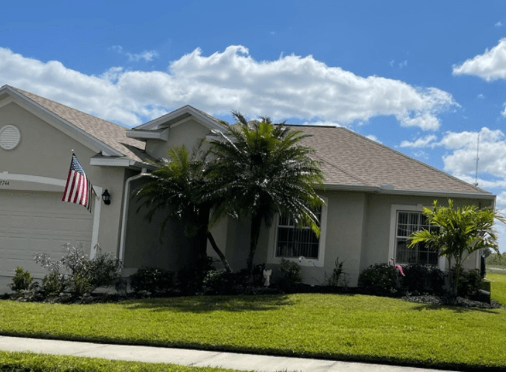A house with a new beige roof installed by Four Peaks Roofing in Cape Coral
