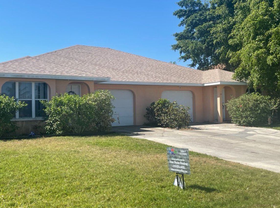 A house with two garages and a roof newly installed by Four Peaks Roofing in Cape Coral