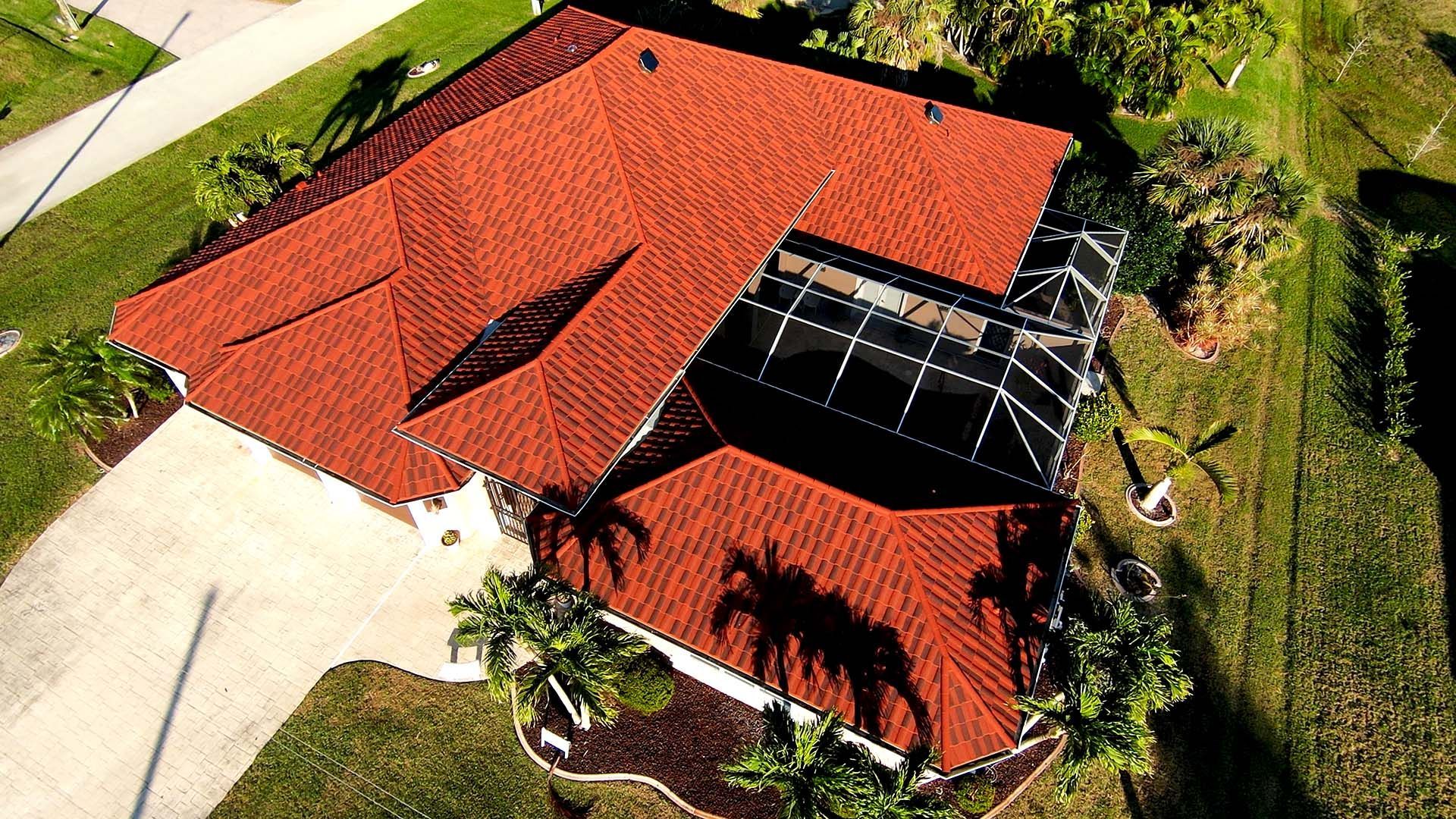 An aerial view of a house with a brand new roof installed by Four Peaks Roofing in Cape Coral
