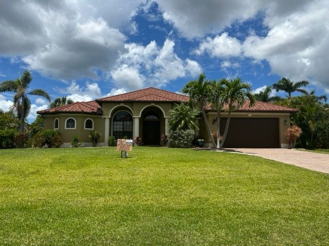 An aerial view of a house with a tiled roof installed by Four Peaks Roofing in Fort Myers