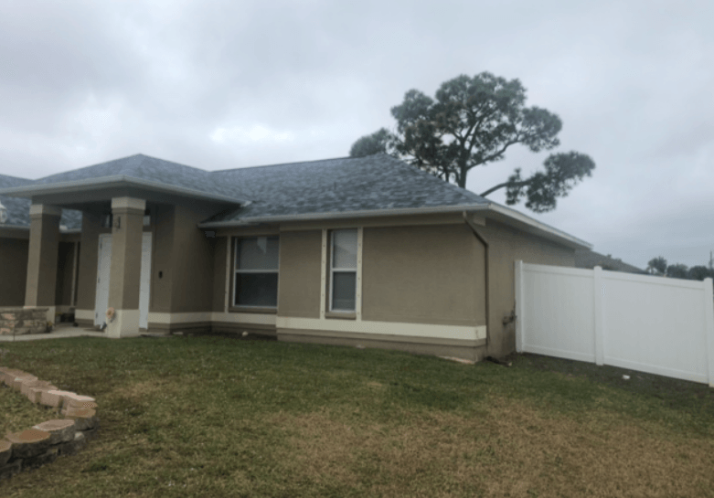 A house with a brand new roof installed by Four Peaks Roofing in Cape Coral