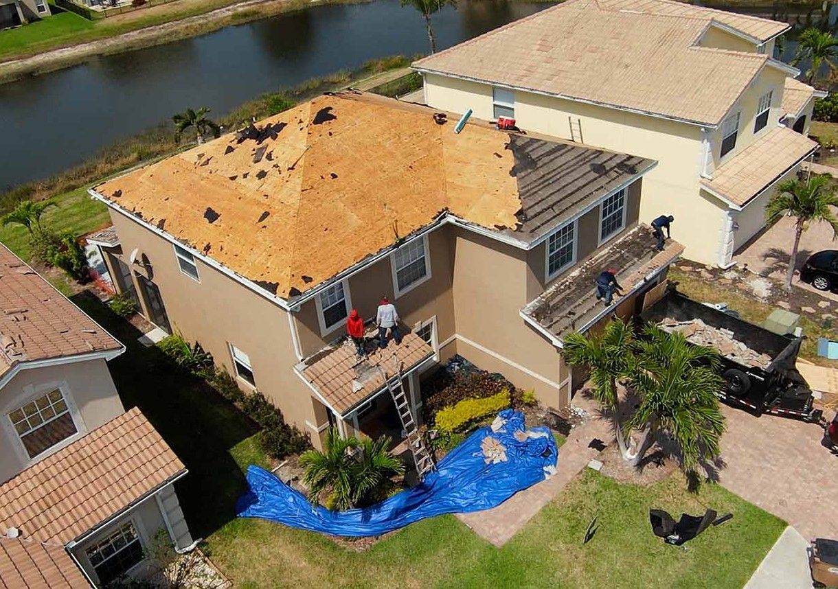 An aerial view of a house undergoing a roof replacement by Four Peaks Roofing in Cape Coral