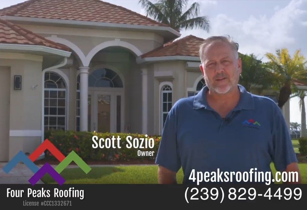 Scott Sozio is standing in front of a house with a new roof installed by Four Peaks Roofing