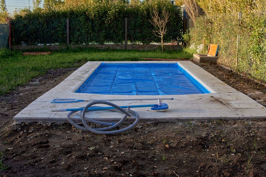 A swimming pool is being built in a backyard.