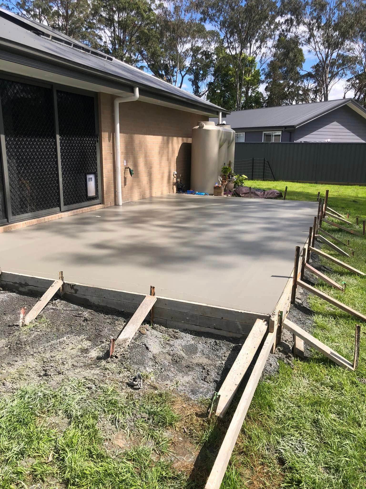 A Freshly Poured Concrete Patio in A Backyard Setting. Forms and Bracing Still in Place — Rhyno’s Concreting In Old Bar, NSW
