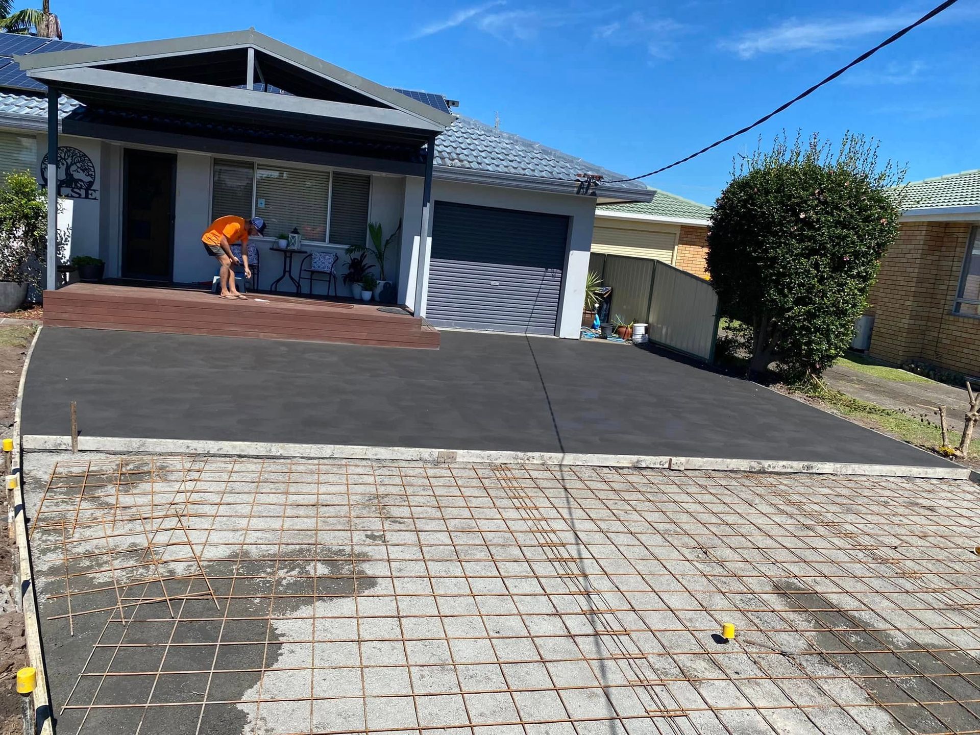 Driveway Under Construction with Exposed Rebar Grid; House in Background — Rhyno’s Concreting In Old Bar, NSW