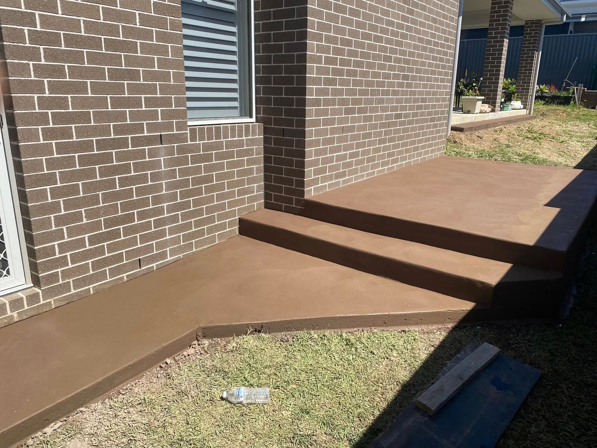 Brown Concrete Steps and Pathway Outside a Brick Building — Rhyno’s Concreting In Old Bar, NSW