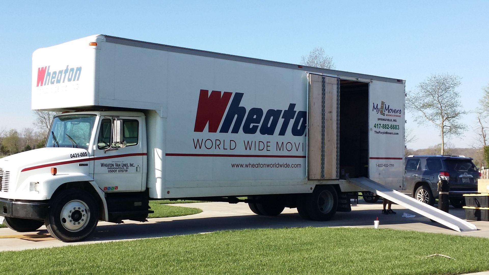 White Wheaton moving truck with ramp extended