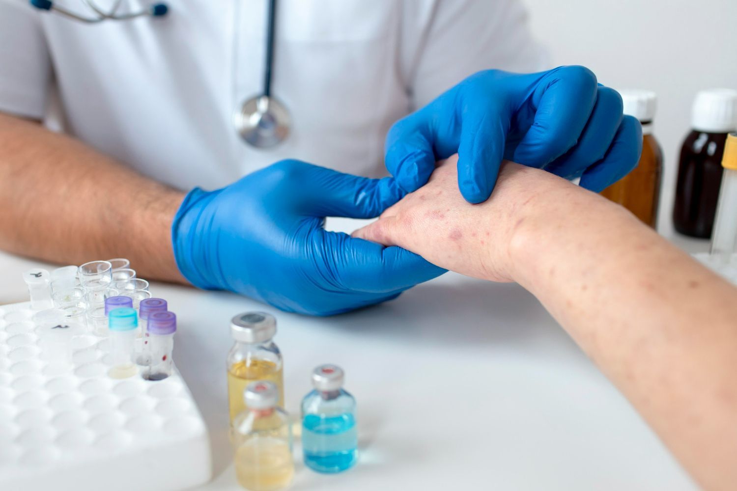 A doctor is examining a patient 's wrist with a bandage.